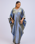 Woman wearing a shiny metallic blue-green cupped chain dress with loose sleeves and embellished neckline.
