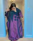 Model wearing luxurious plum and black Arewa Boubou dress with geometric embroidery design.
