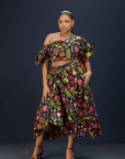 A woman wearing a vibrant floral maxi dress.
